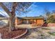 Inviting brick home with a welcoming stone-paved entrance and well-maintained facade at 14091 W Exposition Dr, Lakewood, CO 80228