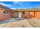 Close-up of the front entrance, showcasing a stone patio and classic brick architecture at 14091 W Exposition Dr, Lakewood, CO 80228