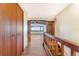 Bright and airy upstairs hallway featuring wood floors and view of living room with mountain views at 14091 W Exposition Dr, Lakewood, CO 80228