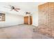 A large living room features a brick fireplace at 14091 W Exposition Dr, Lakewood, CO 80228