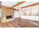 Warm and inviting living room with an open concept to the kitchen and stone fireplace at 14091 W Exposition Dr, Lakewood, CO 80228