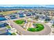 Aerial view of the community featuring a bocce ball court, green spaces, and residential streets at 8820 Whiteclover St, Littleton, CO 80125