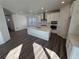 Stylish kitchen with stainless steel appliances, a large center island with a sink, and modern white cabinets at 8820 Whiteclover St, Littleton, CO 80125