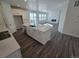 Modern kitchen with a center island, stainless steel appliances, white cabinets, and an adjoining living space at 8820 Whiteclover St, Littleton, CO 80125