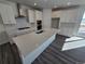 Well-lit kitchen boasts a large island, white cabinets, stainless steel appliances, and a tiled backsplash at 8820 Whiteclover St, Littleton, CO 80125