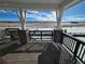 Enjoy breathtaking scenery from this covered porch with brick pillars and wood railing, perfect for relaxation and enjoying the outdoors at 8820 Whiteclover St, Littleton, CO 80125