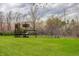 View of backyard with a play structure and swing set, providing a fun and safe outdoor play area at 9445 Lykins Pl, Longmont, CO 80503