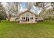 Spacious backyard features patio seating area, lush green lawn, mature trees, and attractive landscaping at 9445 Lykins Pl, Longmont, CO 80503