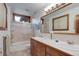 Bright bathroom featuring a double vanity, tiled shower, and ample lighting at 9445 Lykins Pl, Longmont, CO 80503