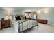 Bedroom featuring a plush bed, side tables, and a decorative mirror at 9445 Lykins Pl, Longmont, CO 80503