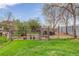 Backyard chicken coop behind a gated fence with chickens roaming on the grass at 9445 Lykins Pl, Longmont, CO 80503
