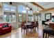 Bright dining room with wood floors, exposed beams, large windows, and a patio access at 9445 Lykins Pl, Longmont, CO 80503
