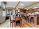 Inviting dining room with hardwood floors, beamed ceilings, a view of the kitchen, and natural light at 9445 Lykins Pl, Longmont, CO 80503