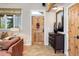 Cozy foyer with stone tile, wooden door, and natural light at 9445 Lykins Pl, Longmont, CO 80503