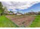 Large tilled garden with rows ready for planting and a house in the background on a farm at 9445 Lykins Pl, Longmont, CO 80503