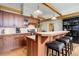 Kitchen featuring wooden cabinetry, a breakfast bar, and modern appliances at 9445 Lykins Pl, Longmont, CO 80503