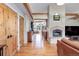 Open-concept living area with wood floors, exposed beams, stone fireplace, and lots of natural light at 9445 Lykins Pl, Longmont, CO 80503