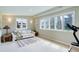 Inviting living area featuring natural light from large windows and comfortable seating arrangement at 9445 Lykins Pl, Longmont, CO 80503