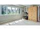 Bright living room with large windows and a wooden storage cabinet at 9445 Lykins Pl, Longmont, CO 80503