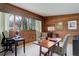 Cozy wood paneled office space with large windows providing natural light at 9445 Lykins Pl, Longmont, CO 80503