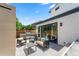 Cozy backyard patio with modern outdoor furniture, including a grill and dining area at 2564 S Carey Way, Denver, CO 80222