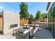 Beautifully landscaped backyard with a fireplace, grilling area, and plenty of seating for entertaining at 2564 S Carey Way, Denver, CO 80222