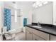 Clean bathroom with a shower-tub combo, modern vanity, and neutral color scheme at 2564 S Carey Way, Denver, CO 80222