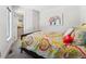 Cozy bedroom with a colorful bedspread and an elephant painting on the wall at 2564 S Carey Way, Denver, CO 80222