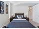 Cozy bedroom with a wooden bed frame, matching nightstands, and soft lighting at 2564 S Carey Way, Denver, CO 80222
