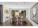 Bright dining room with large table, ample seating, and doors opening to the outdoors at 2564 S Carey Way, Denver, CO 80222