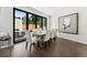 Elegant dining room with large sliding doors opening to the outdoor patio and modern decor at 2564 S Carey Way, Denver, CO 80222