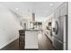 Spacious kitchen with breakfast bar, stainless steel appliances, and modern lighting fixtures at 2564 S Carey Way, Denver, CO 80222