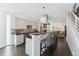 Bright kitchen with stainless steel appliances, island seating, and stylish pendant lights at 2564 S Carey Way, Denver, CO 80222