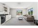 Bright living room with a kitchenette, comfortable seating, and sliding glass doors to a balcony at 2564 S Carey Way, Denver, CO 80222