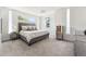 Bright main bedroom with neutral tones and modern decor, featuring large windows and plush carpeting at 2564 S Carey Way, Denver, CO 80222