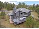 Aerial view of the home with a large deck perfect for outdoor entertaining and relaxing at 1423 Belford Ct, Evergreen, CO 80439