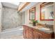 Bathroom with double vanity, granite countertop, and shower over tub at 1423 Belford Ct, Evergreen, CO 80439