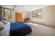 Well-lit bedroom with carpeted floor, chair, windows, and a closet at 1423 Belford Ct, Evergreen, CO 80439