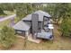 Stunning exterior elevation of the home, featuring a spacious deck surrounded by mature trees at 1423 Belford Ct, Evergreen, CO 80439