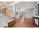 Inviting foyer featuring a staircase, hardwood floors, and dining area access at 1423 Belford Ct, Evergreen, CO 80439