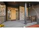 Cozy front porch with stone accents, natural wood door, and space for seating at 1423 Belford Ct, Evergreen, CO 80439