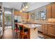 Bright kitchen featuring wooden cabinets, granite countertops, an island, and stainless steel appliances at 1423 Belford Ct, Evergreen, CO 80439