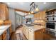 Well-equipped kitchen featuring wooden cabinets, granite countertops, an island, and stainless steel appliances at 1423 Belford Ct, Evergreen, CO 80439