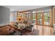 Open-concept living room with wood floors, exposed beams, deck access, and natural light at 1423 Belford Ct, Evergreen, CO 80439
