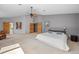 Large main bedroom with a ceiling fan, plush carpet, and an ensuite bathroom with a walk-in closet at 1423 Belford Ct, Evergreen, CO 80439