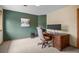 Home office space with dark green accent wall and well-lit desk, ideal for working at home at 1423 Belford Ct, Evergreen, CO 80439