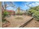 Landscaped backyard featuring a gravel surface, raised planting beds, and mature trees for a serene outdoor space at 14867 E Harvard Ave, Aurora, CO 80014