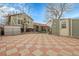 Large paved patio with a fenced backyard offering both privacy and space, complemented by a brick garden at 14867 E Harvard Ave, Aurora, CO 80014