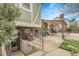 Spacious backyard with an outdoor seating area, including a table with chairs and a small garden at 14867 E Harvard Ave, Aurora, CO 80014