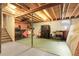 Unfinished basement with visible ceiling beams and ample space for storage, organization and utility at 14867 E Harvard Ave, Aurora, CO 80014